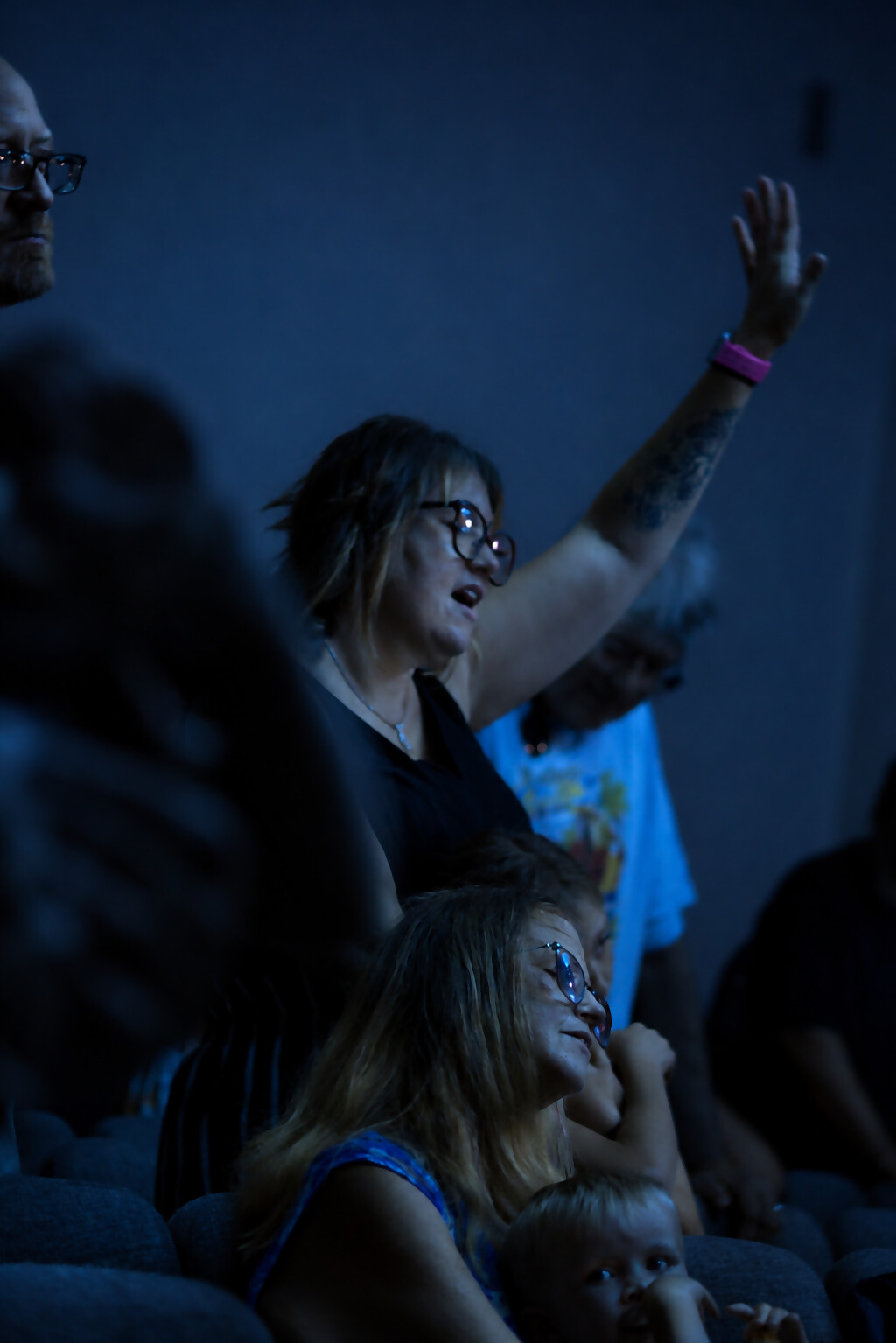 Hands raised in worship during a Sunday gathering